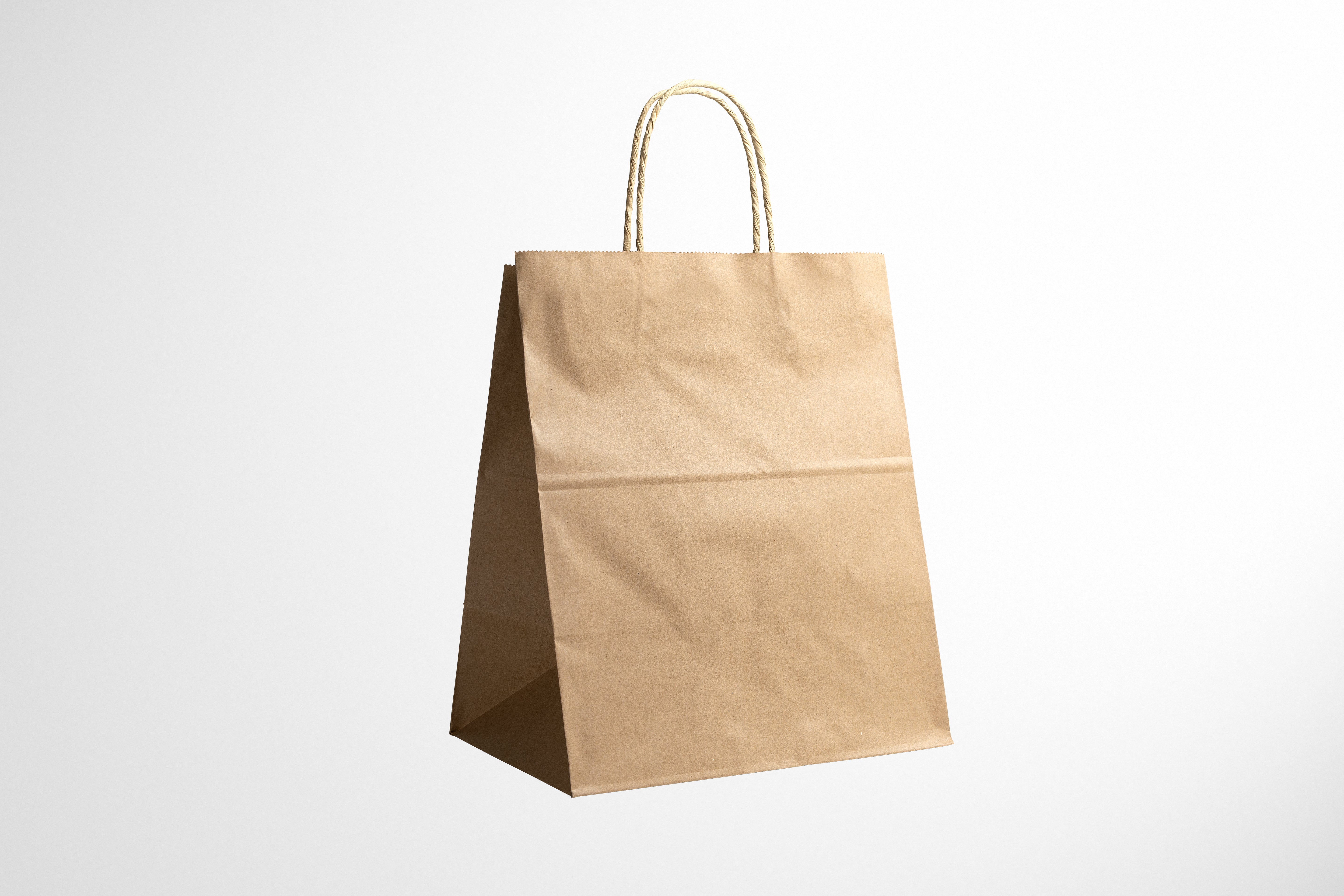 Eco-friendly kraft paper bags for retail packaging, durable and customizable.