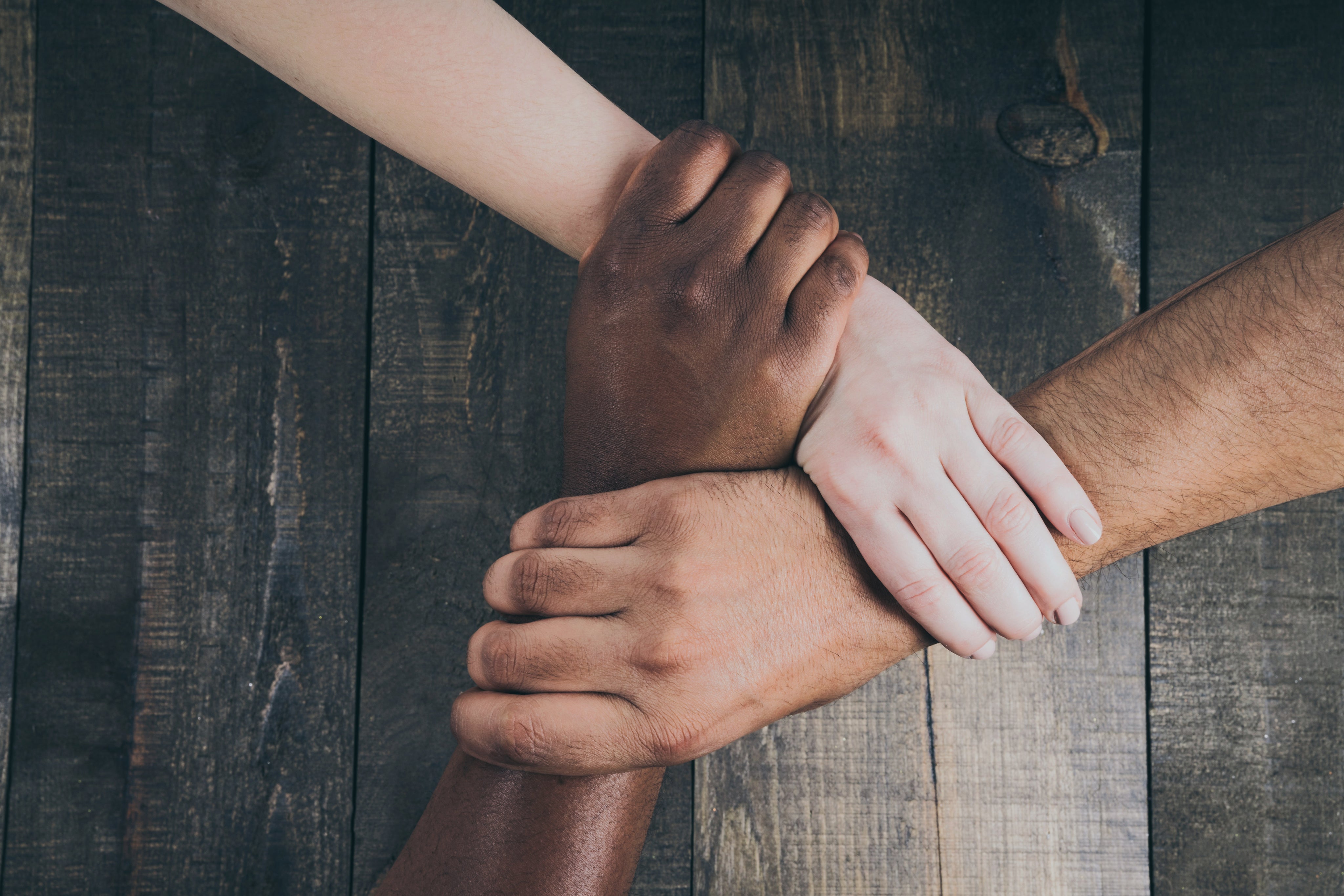 social responsibility, team hands linked together